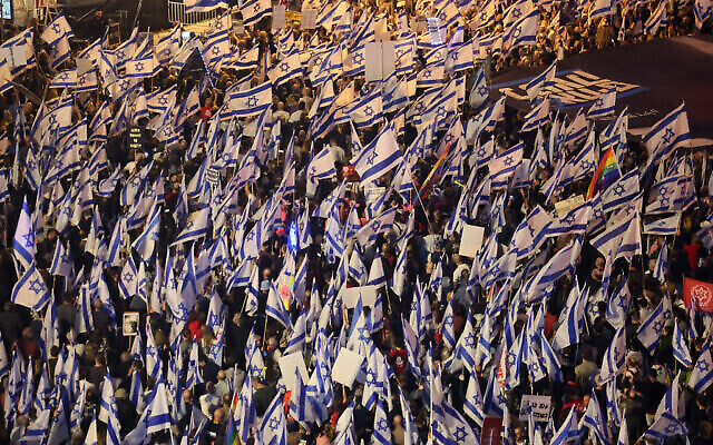 متظاهرون يلوحون بالاعلام خلال مظاهرة احتجاجية على خطط الحكومة الاسرائيلية للاصلاح القضائي،  تل ابيب، 22 أبريل، 2023. (JACK GUEZ / AFP)