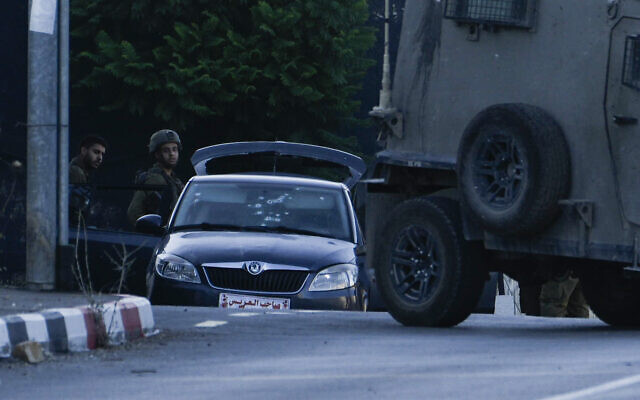جنود إسرائيليون يقفون بجانب سيارة استخدمها ثلاثة مسلحين فلسطينيين، بعد مقتلهم بالقرب من مدينة نابلس بالضفة الغربية، 25 يوليو 2023 (AP Photo / Majdi Mohammed)