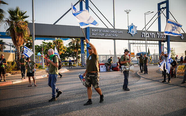 متظاهرون يغلقون مدخل ميناء حيفا خلال احتجاج على خطة الحكومة لإصلاح القضاء، 3 يوليو، 2023. (Shir Torem / Flash90)