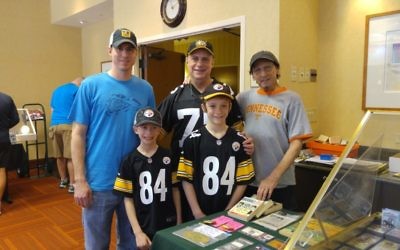 Frank Moiger (right) welcomes a longtime customer and friend, Harvey Linder, to one of his sports collectible shows. With Linder are his sons, Zal (back left), Aaron and grandson Aiden (front left).