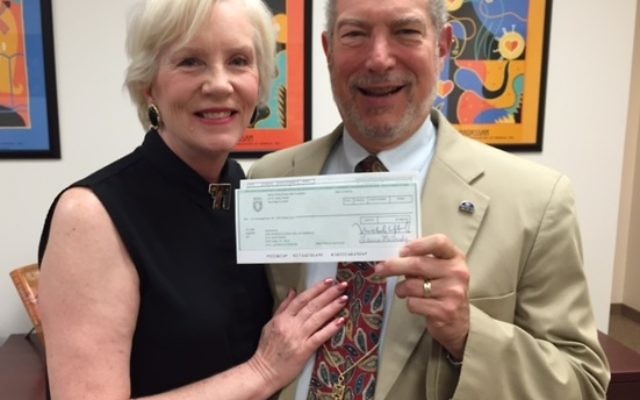 Bill Loventhal presents Hadassah Greater Atlanta President Paula Zucker a $5,000 check from the Million Dollar Round Table Foundation.