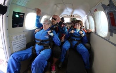 Rose Tucker (left) and Nesie Summers prepare for their 14,000-foot jump out of a plane.