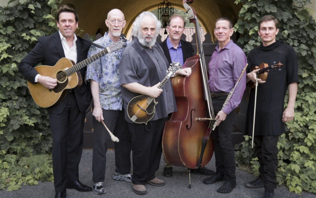 The David Grisman Sextet with David Grisman (mandolin) center. The remaining members of the group are Jim Kerwin (bass), Matt Eakle (flute), George Marsh (percussion), Chad Manning (fiddle) and George Cole (guitar). 