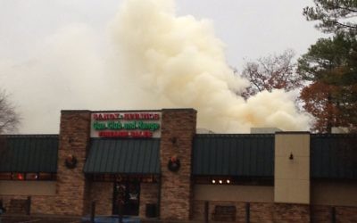 A fire burns through the roof of the Sandy Springs Gun Club and Range on Dec. 4. (Photo courtesy of the city of Sandy Springs)