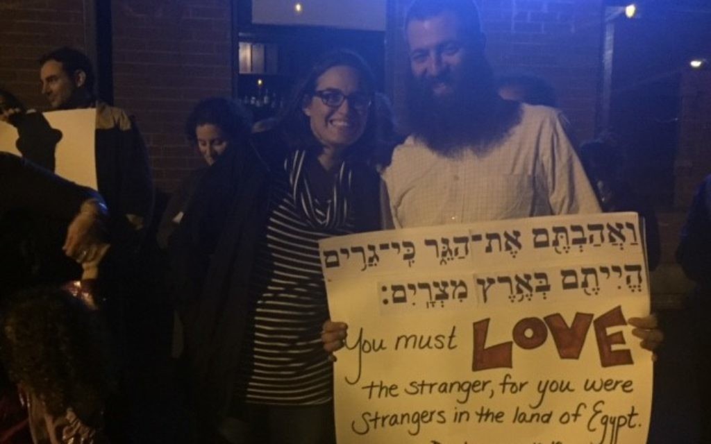 #JewishResistance protesters Kelly and Drew Cohen hold a sign expressing support for love and acceptance.