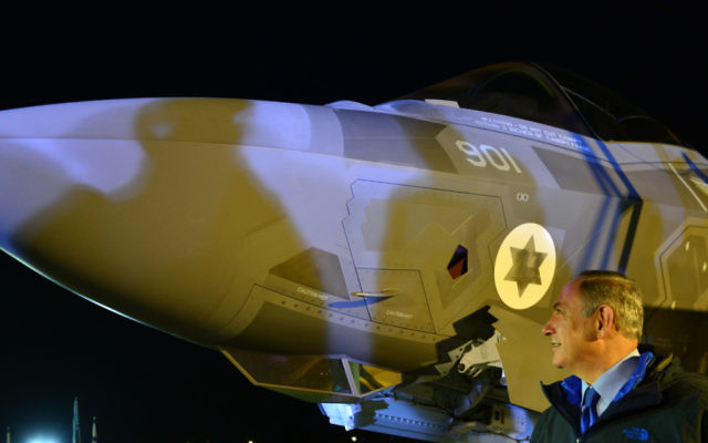 One of the first two F-35 Adir jets sits at Nevatim Air Force Base behind Prime Minister Benjamin Netanyahu on Dec. 12.  (Photo by Kobi Gideon, Government Press Office)