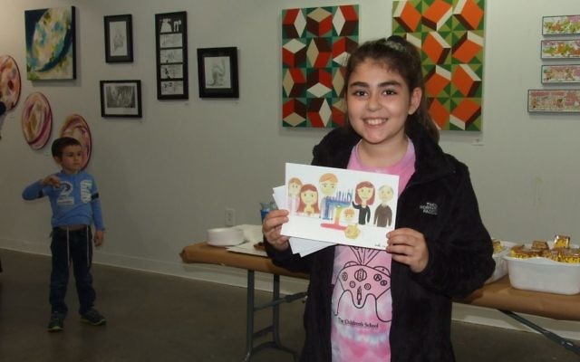 Amelia Andrews shows the drawing that earned her runner-up recognition among 10- to 12-year-olds.