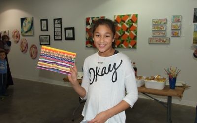 Lila Ross has the winning entry in the 10-to-12 age group with the layers of colors in her menorah art.