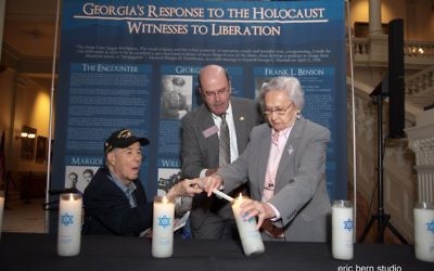 At the Aug. 17, 2015, Days of Remembrance ceremony held at the Georgia Capitol, liberator Howard Margol and Holocaust survivor Elizabeth Lefkovits light a memorial candle with the help of state Rep. Bruce Broadrick (R-Dalton). (Photo by Eric Bern)