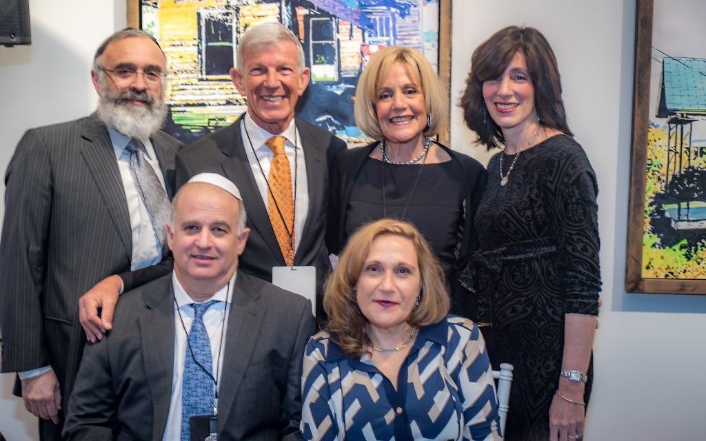 Rabbi Yossi New and Dassie New flank honorees Michael and Rita LeVine (standing) and Ian and Yaarit Silverstone. --- Photos by J. Braxton Photography