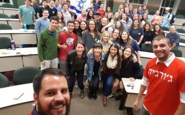 Israeli soldiers Ilan and Marc (in front) pose with most of the students who attended their StandWithUs talk Feb. 21.