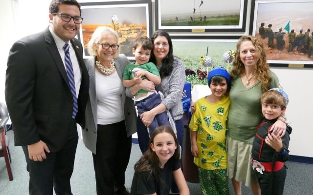 Yael Pritzker and her 3-year-old son, Avi, and Yael Waknine and her sons, Micah Weiss, 8, and Avi Weiss, 6, visit the AJT offices Friday, March 10, to receive the prize of an Israel Box from Israeli Consul General Judith Varnai Shorer