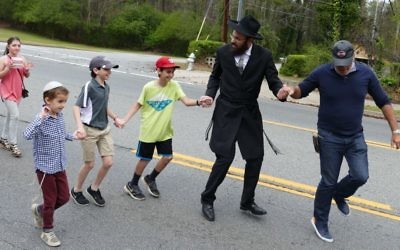 Rabbi Ephraim Silverman leads the street dancing.
