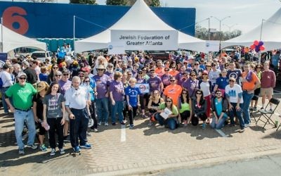 Photo courtesy of Federation
Atlanta Community Food Bank President and CEO Kyle Waide (kneeling, in orange) joins the Jewish community’s Hunger Walk/Run participants in front of the Federation tent in March 2017.