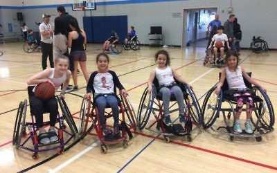 Able-bodied girls get to try out wheelchair basketball at the Marcus JCC Feb. 26.