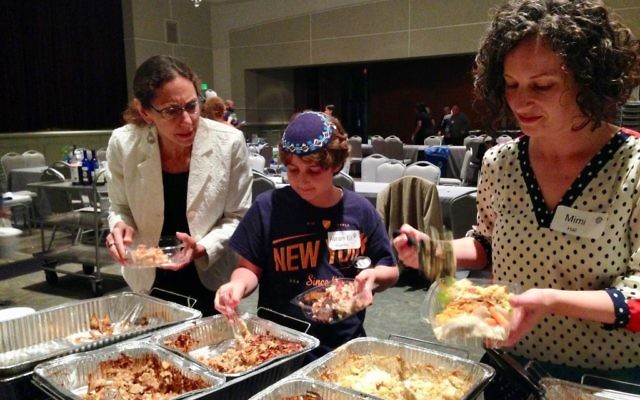 Audrey Galex, Avram Eli Rosenthal and Mimi Hall package individual meals for distribution after the 2016 Hunger Seder.