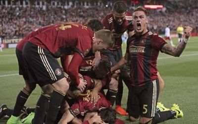 Atlanta United players celebrate the historic opening goal by Yamil Asad against the New York Red Bulls.