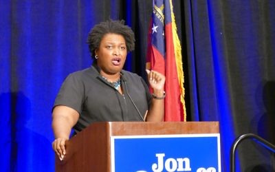 House Minority Leader Stacey Abrams, a likely candidate for governor next year, rallies the Ossoff crowd at the Crown Plaza Ravinia.
