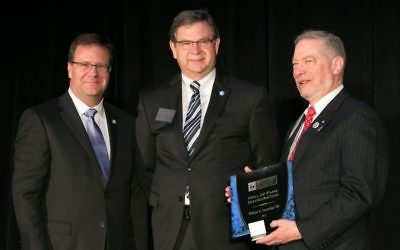 Bill Loventhal (right) receives a Riskie Award from Richard Phillips (left), the dean of risk management and insurance in the J. Mack Robinson College of Business, and David Buechner, the director of the Georgia State University Risk Management Foundation.