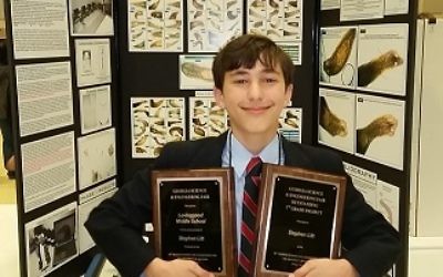 Stephen Litt shows the awards for his science fair project on antioxidants in green tea that inhibit the growth of tumors.