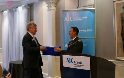 AJC regional director Dov Wilker presents outgoing president Gregg Averbuch with a parting gift on behalf of the AJC.