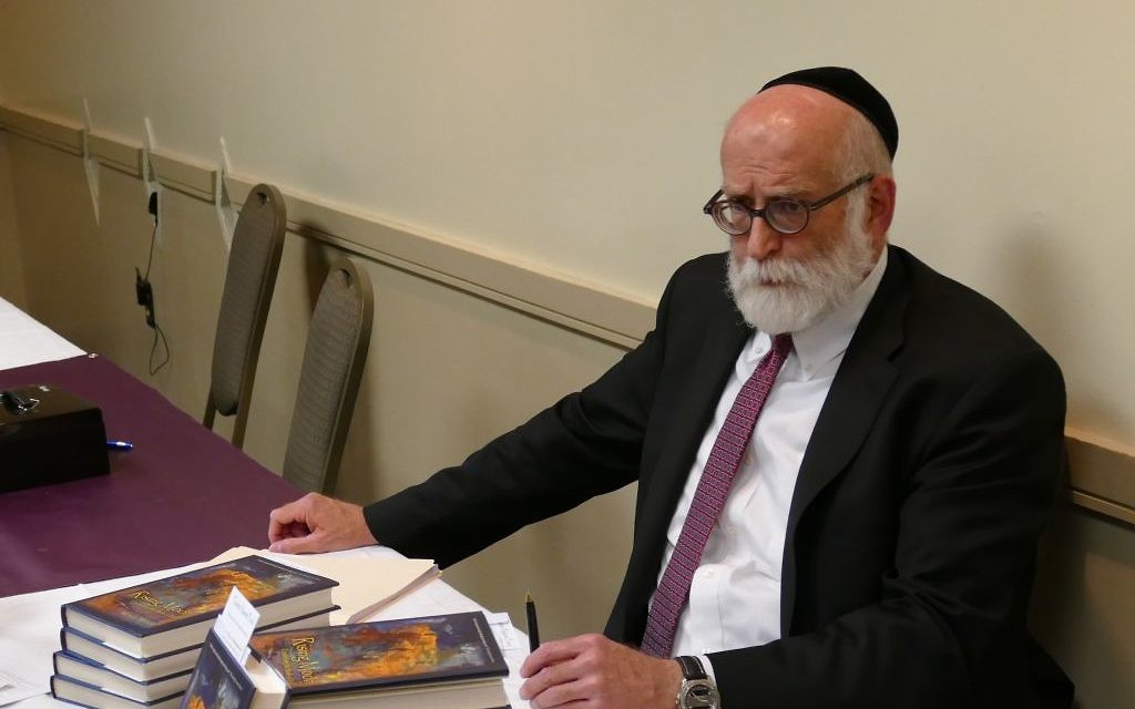 Rabbi Moshe Miller signs and sells books May 11 to benefit the Tzarkei Naomi Fund.