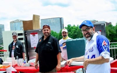 Rabbi Reuven Stein, the Atlanta Kosher Commission’s director of supervision, keeps an eye on the operations of Keith Marks and his Keith’s Corner Bar-B-Que crew during Kosher Day.