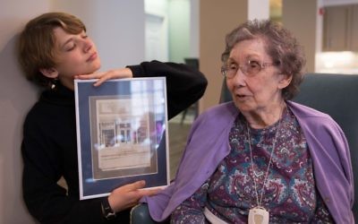 Eli Abeita (left) and Dian Biddle look at a photograph called “The Bakery Story” by Ori Salzberg.