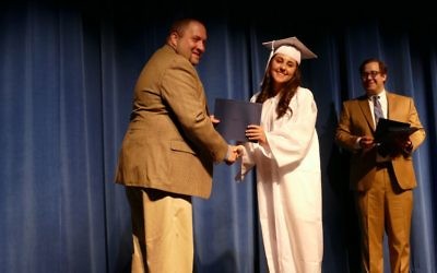 Talia Barras accepts her diploma from Associate Head of School and Principal Drew Frank.