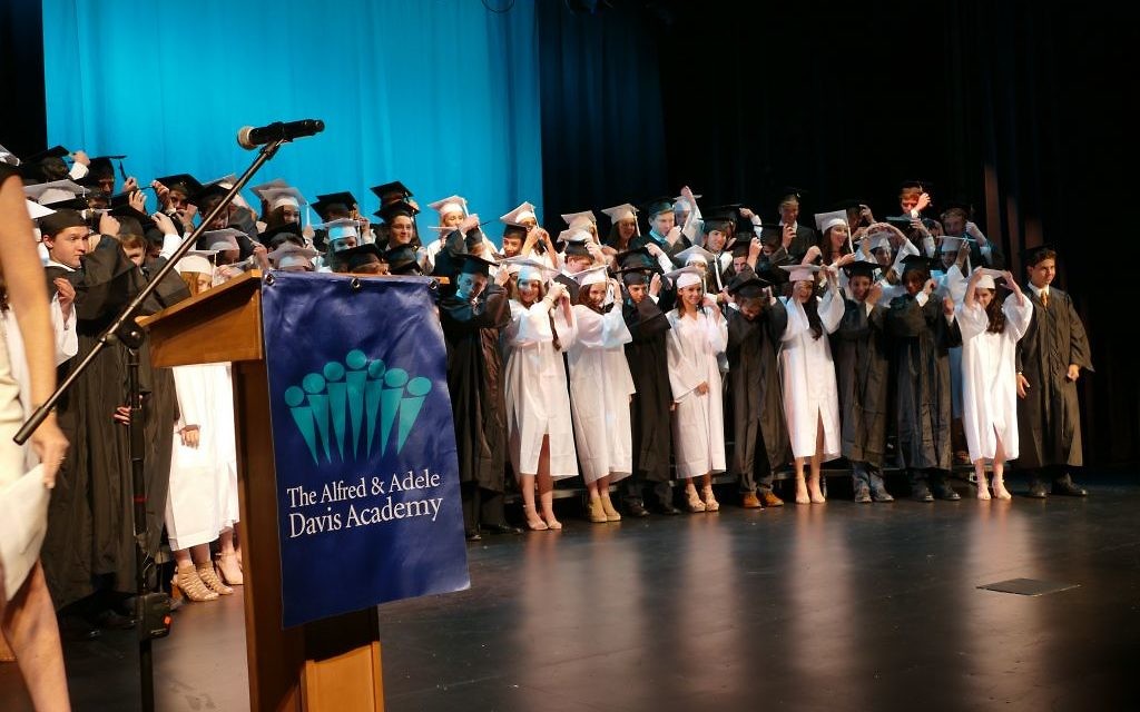 The Davis Academy Class of 2017 follows tradition by flipping tassels from right to left to mark graduation.