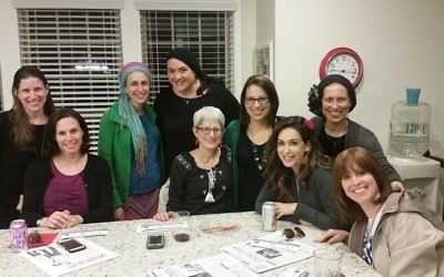 Elana Frank (fourth from right) works with the committee planning infertility sensitivity training. More than 80 mikvah guides and rebbetzins participated in the training.