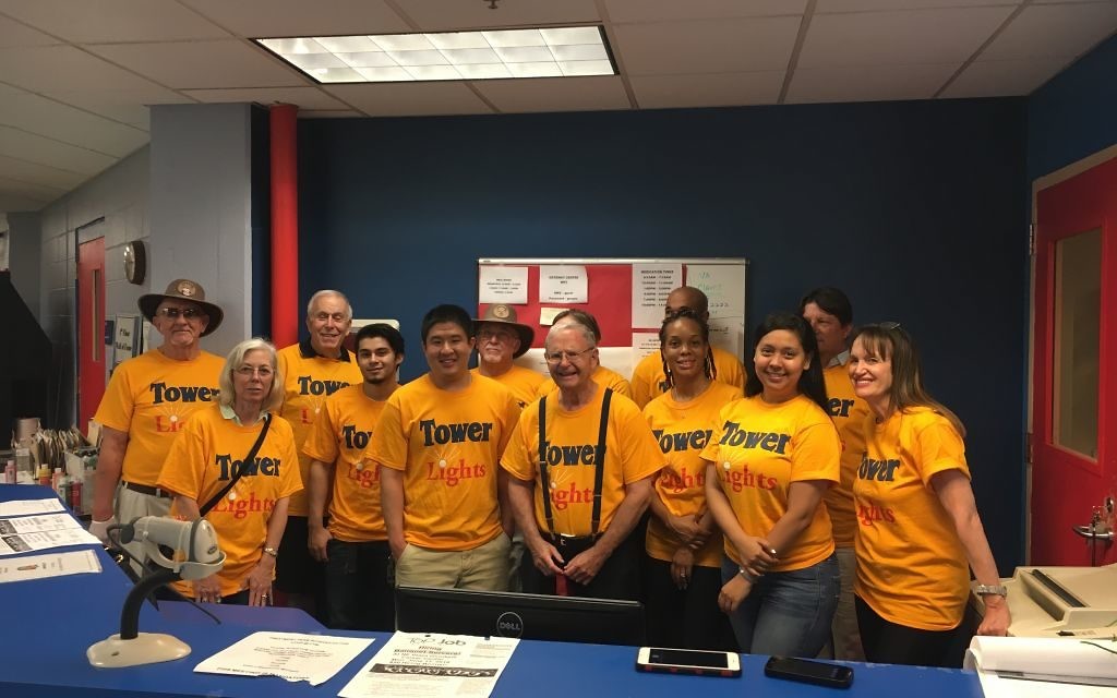 Michael Greenbaum poses with Tower Lights members at a volunteer event.