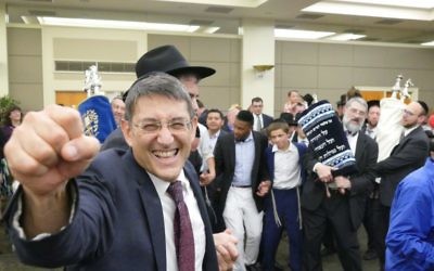 The Atlanta Scholars Kollel’s Rabbi David Silverman is at the center of the Torah dancing before the sanctuary dedication.