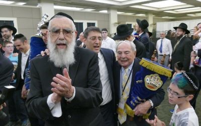 Congregation Beth Jacob Rabbi Emeritus Emanuel Feldman is joined by Atlanta Scholars Kollel Rabbi David Silverman and past shul President Bob Maran at the center of the Heritage Hall dancing to celebrate the completion of a new Torah on July 9.