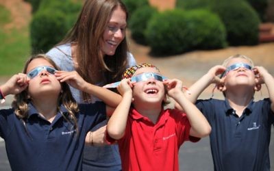 The scene in the early afternoon at the Epstein School is typical of schools and workplaces around metro Atlanta on Aug. 21: eyes shielded by special glasses, staring at the mostly eclipsed sun.