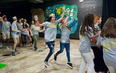 Photo by Andria Lavine Photography
Sporting Waffle House-style shirts and hats, members of the Weber School Class of 2018 charge into the basement theater to celebrate the first day of their last year of high school Aug. 14.