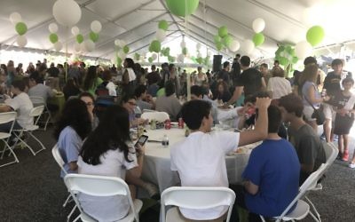 Photo by Rachel Fayne A tent decorated with white and green balloons serves as the dining room for a Fox Bros. Bar-B-Q lunch.