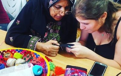 A Bedouin woman teaches embroidery to a Fashionating Israel participant.