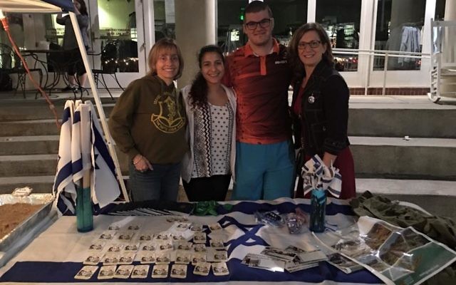 Rabbi Judith Schindler (left) is joined by Inbal Ozeri, Noah Goldman and Talli Dippold at the Israel table at the Queens Trip Around the World event.