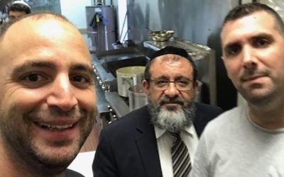 Tip Top Kosher Market owners Yehonatan Hazot (left) and David Malka have Congregation Ner Hamizrach Rabbi Shmuel Khoshkerman in their store.