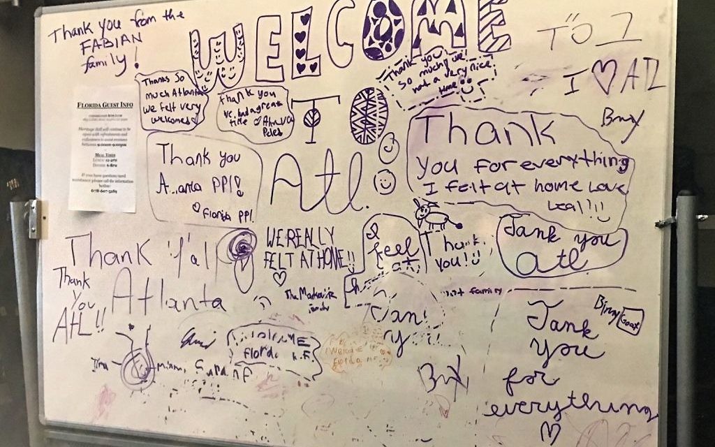 Temporary guests from Florida express their appreciation on a whiteboard in heritage Hall at Beth Jacob. This photo was taken around midnight Sunday night, after the refrigerator truck operation was completed. (Photo by Jodi Wittenberg)