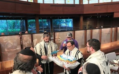 Rabbis Ilan Feldman and Adam Starr continue the Beth Jacob-Young Israel cooperation by officiating at the bris of the first evacuee baby born in Toco Hills.