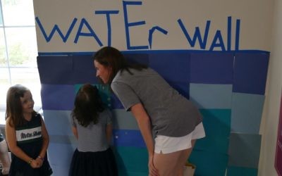 The first of two events on consecutive weekends packing supplies and care packages for Texas includes education for the young do-gooders, such as a wall showing flood levels in Houston.