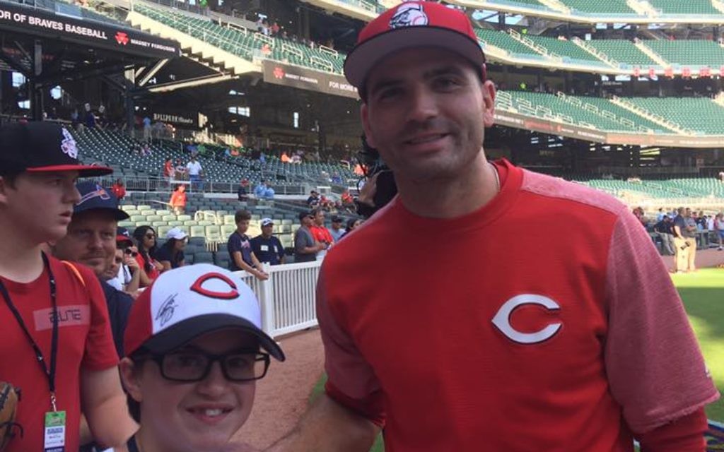 Adam Koss poses for a photo with Reds first basemen Joey Votto at SunTrust Park.