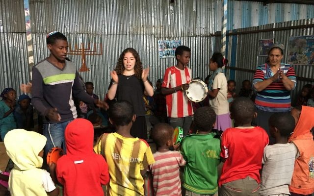Dalia Hartstein teaches Ethiopian children some Hebrew songs.