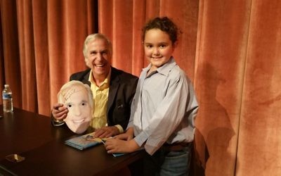 Dylan Dickson — the 9-year-old author of “Why Can’t I Read?” — meets her hero, fellow author and fellow person with dyslexia, Henry Winkler, at the Decatur Book Festival, where he was signing copies of one of his “Hank” series of books. Dylan, who wore a Winkler mask to the event, will join Gail Saltz at her appearance at the Book Festival of the Marcus JCC on Nov. 5.