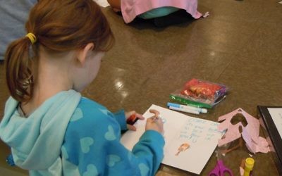 While the adults were in the sanctuary and other parts of Temple Emanu-El talking about problems and policies Oct. 22, religious school students were in the social hall, working on cards and care packages for distribution through The Packaged Good.