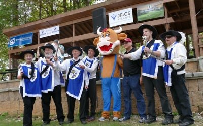 Posing alongside official mascot brisket the bull, the Brisketeers celebrate a third-place finish in brisket at the 2017 Atlanta Kosher BBQ Festival. (Photo by Michael Jacobs)