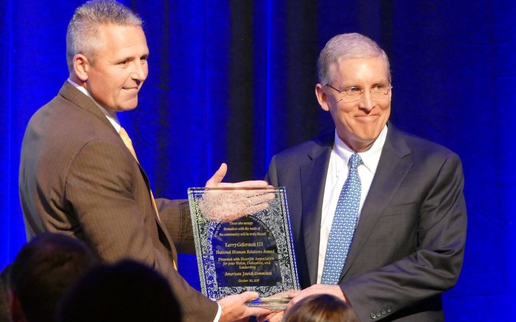 Larry Gellerstedt III (right) accepts the AJC National Human Relations Award from last year’s winner, Jim Hannan, an executive vice president with Koch Industries.