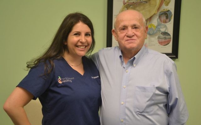 Peachtree Hearing audiologist Melissa Wikoff and Holocaust survivor Hershel Greenblat are all smiles after Greenblat gets his hearing aids.